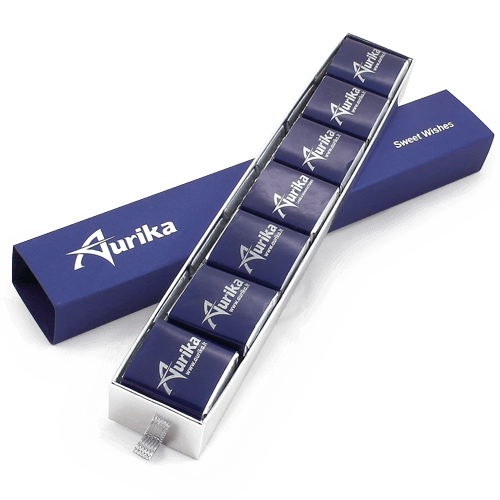 Compact, narrow pencil case shaped box with promotional chocolates. 

The logo looks best pressed in metallized foil.