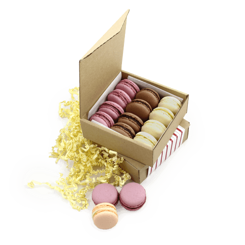 Warm and cozy Christmas set with gourmet sweets. Almond delicacies Macarons 
in the box with the logo. Box from the brown cardboard. The logo can be carved on the cover, print on the sleeve, ribbon or postcard.