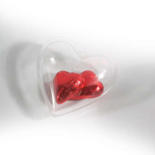Stylized Heart-shaped box from clear plastic with eyehole for hanging or 
ribbon. Box is made from two lockable parts. Suitable for small souvenir or candy packaging or as a decoration.